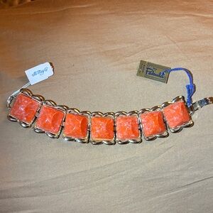 Vintage 1960s orange thermoset gold-tone link bracelet.